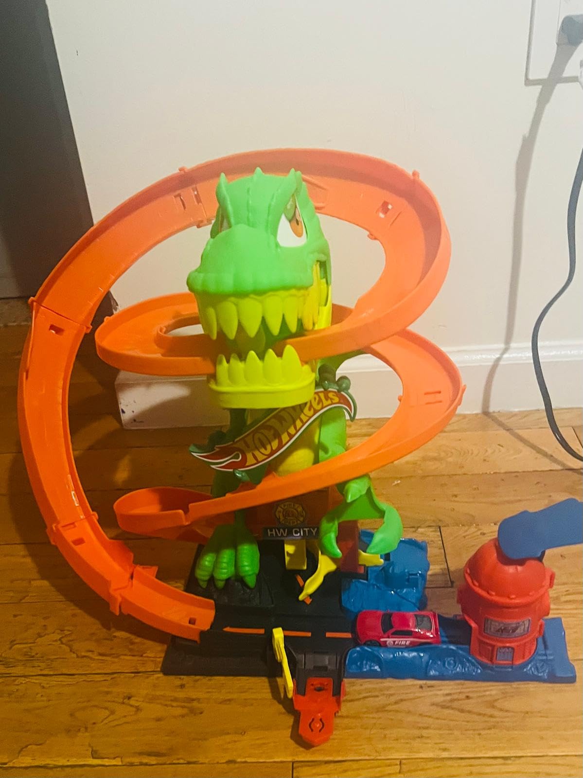 Hot Wheels Toy Car Track Set, City T-Rex Blaze Battle Playset & 1:64 Scale Die-Cast Vehicle, 18